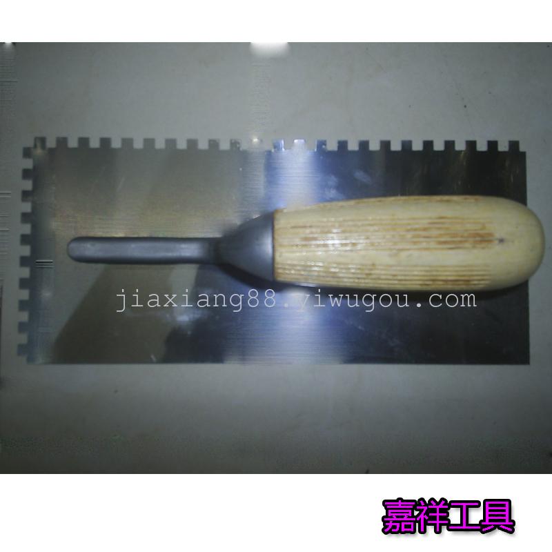A tooth putty knife with wooden handle trowel plate scraper scraper knife knife cement brick hardware tools