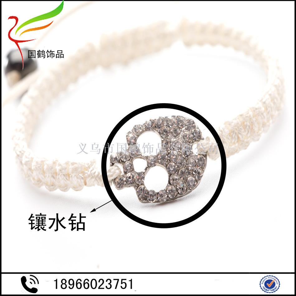 Diamond-encrusted skull with hand woven men's bracelet. Diamond-encrusted skull with hand woven men's bracelet.