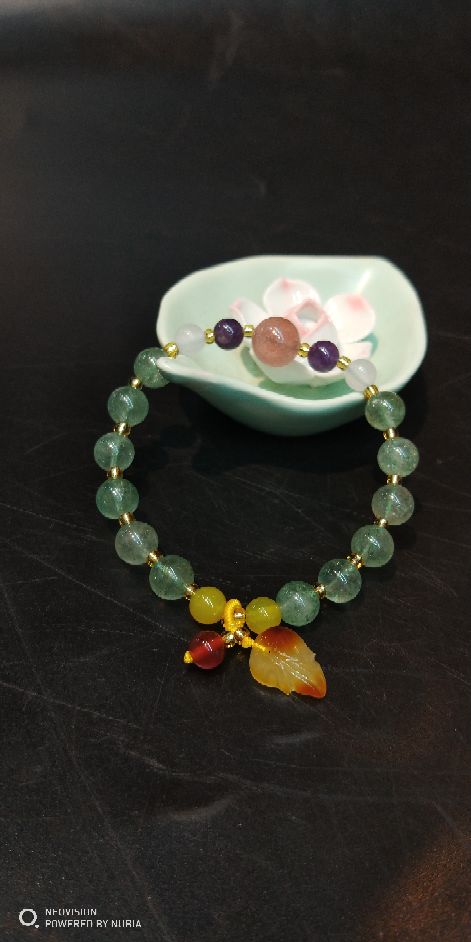 The natural green strawberry crystal bracelet matches The original mine beeswax pendant bracelet