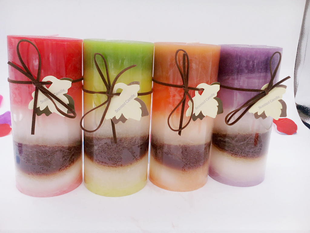 Leaves are tied with irregularly layered circular wax wedding candles