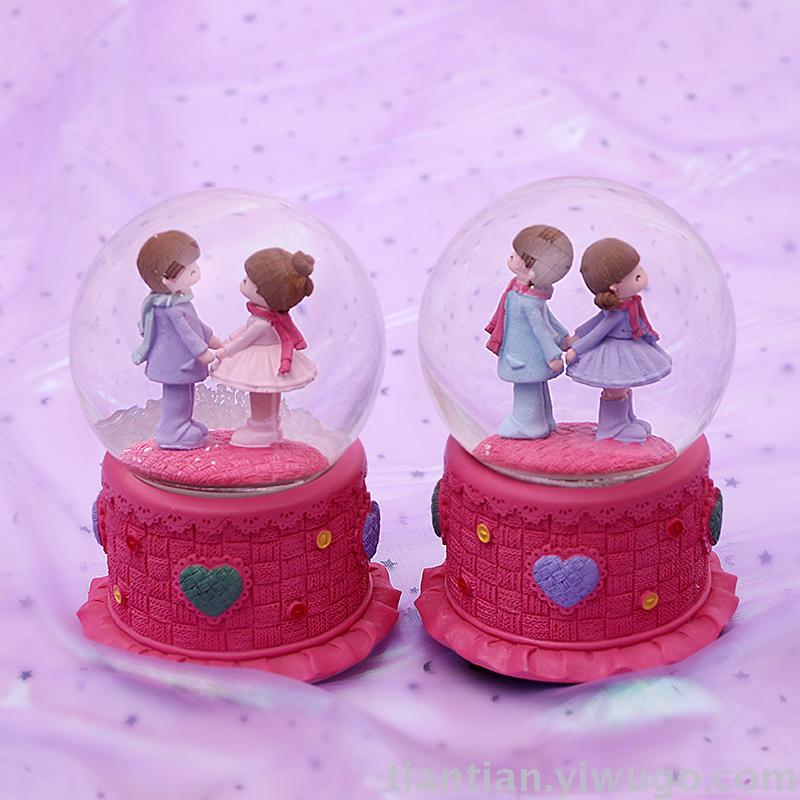 The whole family has excellent presents a couple holding hands with a crystal ball music box dreamlike glow Snowflake music box