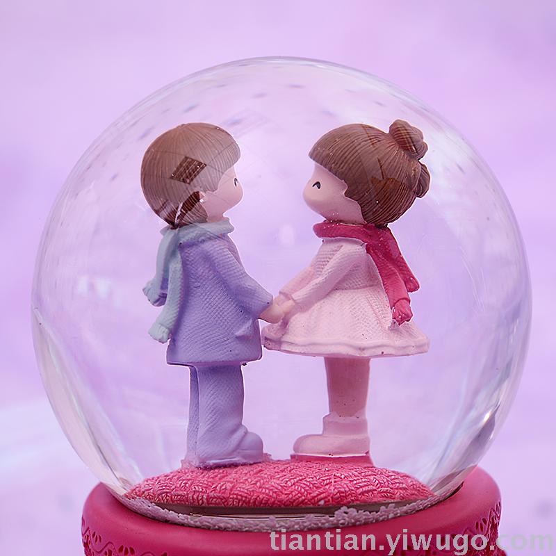 The whole family has excellent presents a couple holding hands with a crystal ball music box dreamlike glow Snowflake music box