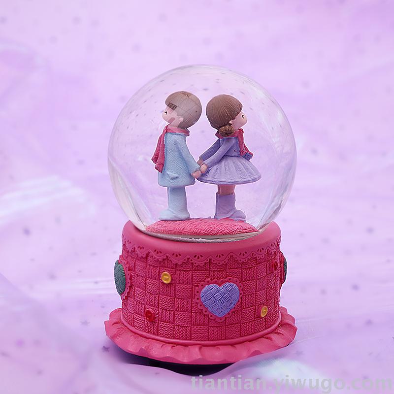 The whole family has excellent presents a couple holding hands with a crystal ball music box dreamlike glow Snowflake music box