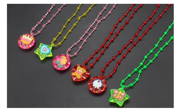 The ground stall sells novelty toys to shine necklace led flash yakeli bead cartoon pendant child gift