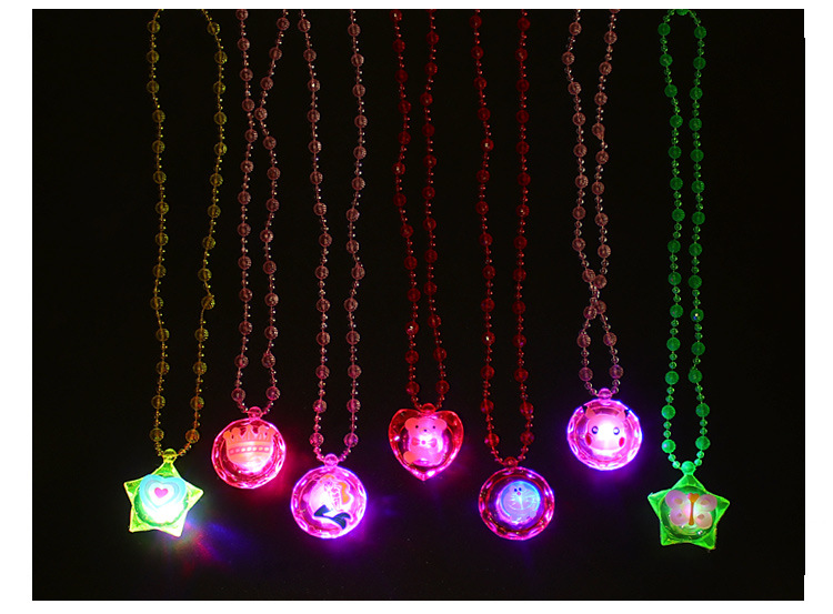 The ground stall sells novelty toys to shine necklace led flash yakeli bead cartoon pendant child gift