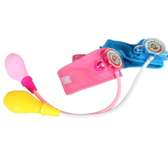 A child's imitation family doctor's toy takes blood pressure of a little doctor and nurse