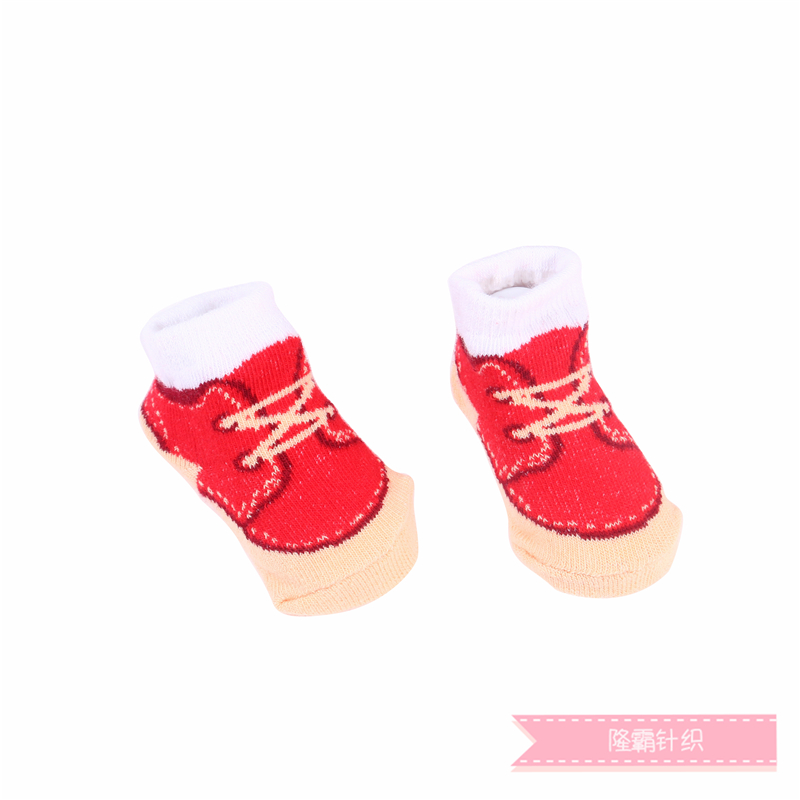 Three pairs of baby shoes in a gift box