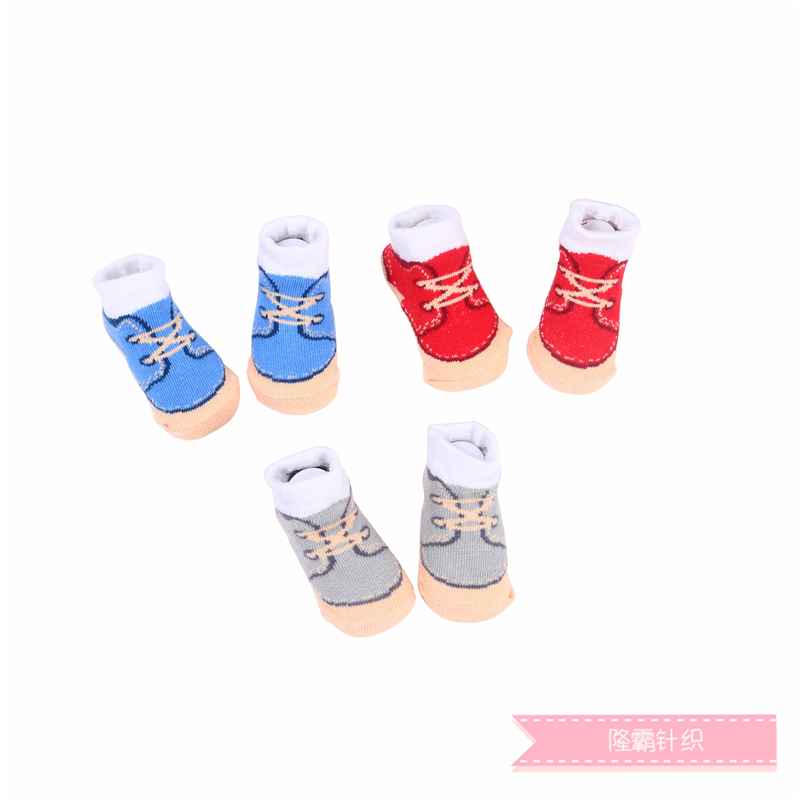 Three pairs of baby shoes in a gift box