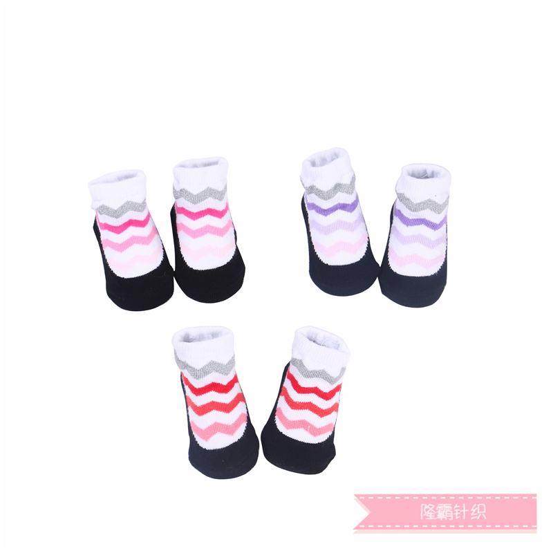 Three pairs of baby shoes in a gift box