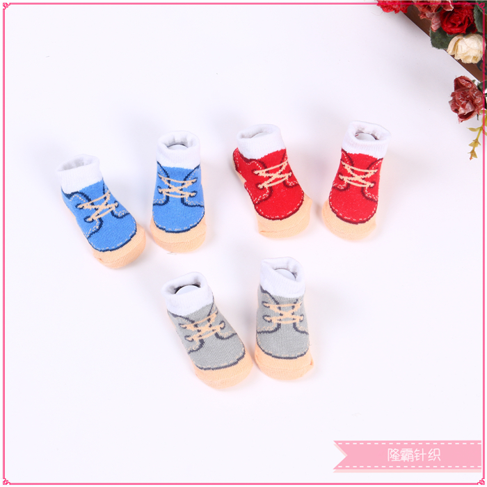 Three pairs of baby shoes in a gift box