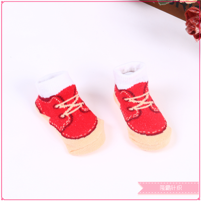 Three pairs of baby shoes in a gift box