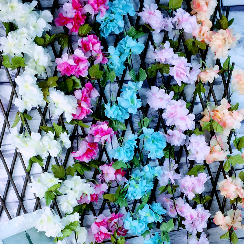 Artificial flower wrapped flower - winding, air - conditioning duct, plastic silk flower pipe wall hanging background.